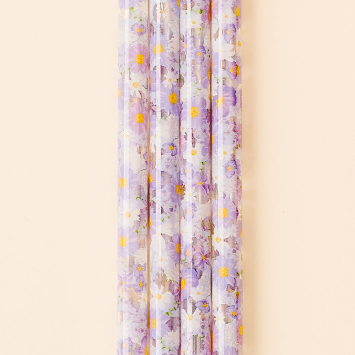 Five translucent, BPA-free Bouquet Beauty Purple 40 oz Tumbler Straws by the-darling-effect, featuring purple and white flowers with yellow centers, are arranged vertically against a beige background.