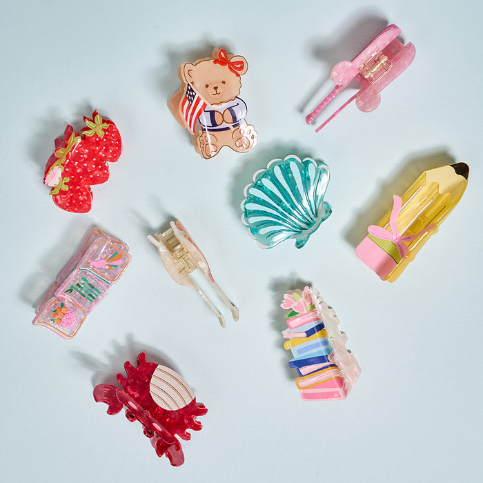 The Darling Effect Mahjong Tiles Shape Up Claw Clip features a playful mahjong tile design in bright colors—perfect for adding a cute, novelty touch to your hairstyles.