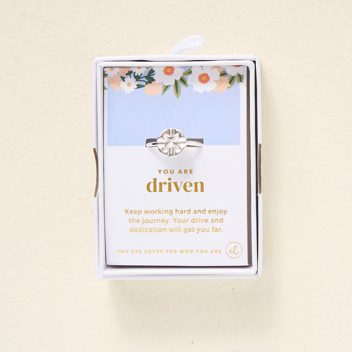 The Darling Effect's You Are Driven Adjustable Ring comes in a white box with a floral design and includes a motivational card that reads: You are driven. Keep working hard and enjoy the journey. Your drive and dedication will get you far.