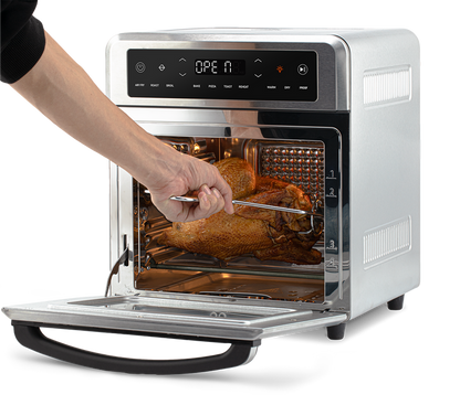 Using the fetch tool to safely remove the rotisserie spit with chicken from the Cosori Air Fryer Oven