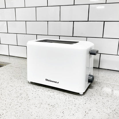 The 2 slice white toaster placing on a marble countertop.