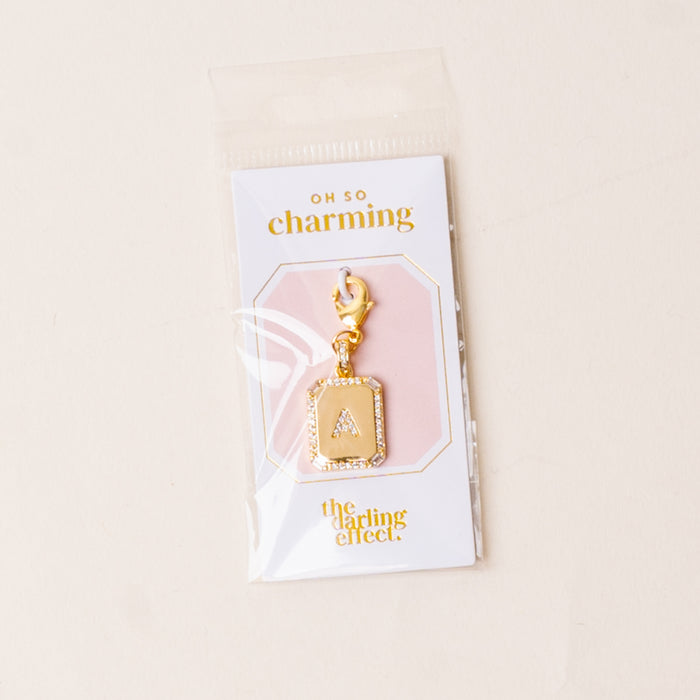 A Jewelry Charm Initial Letter Gold by the-darling-effect features a gold-plated “A” with rhinestone border, lobster clasp, and comes on an “oh so charming” branded card—perfect for personalized style.