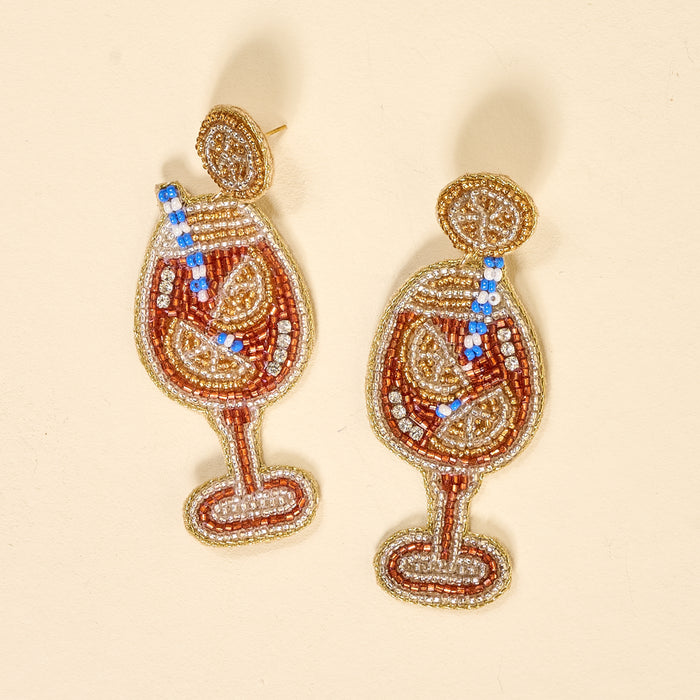 The Darling Effect’s Aperol Spritz Beaded Earrings feature cocktail glass designs with citrus slices and striped straws—an eye-catching, playful addition to your beaded jewelry collection.