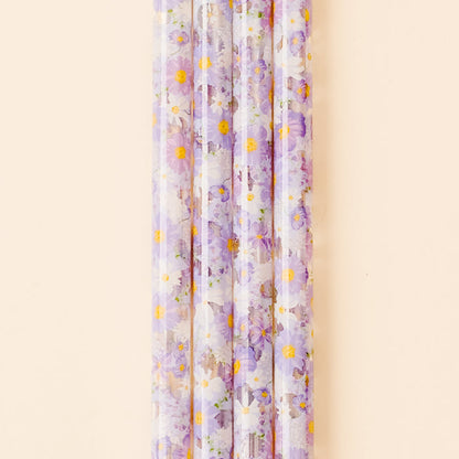 Five translucent, BPA-free Bouquet Beauty Purple 40 oz Tumbler Straws by the-darling-effect, featuring purple and white flowers with yellow centers, are arranged vertically against a beige background.