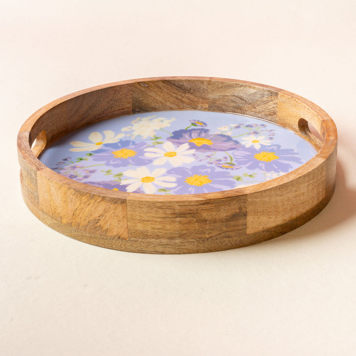 Serve in style with the-darling-effect Bouquet Beauty Purple Large Round Wood Enamel Tray, featuring handles and a light blue base with a purple and white floral design—an elegant choice for gatherings.