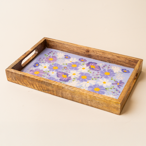 The-darling-effect’s Bouquet Beauty Purple Rectangle Wood Enamel Tray features cutout handles and a floral design with white, yellow, and purple flowers on a light purple background—an elegant piece for any occasion.