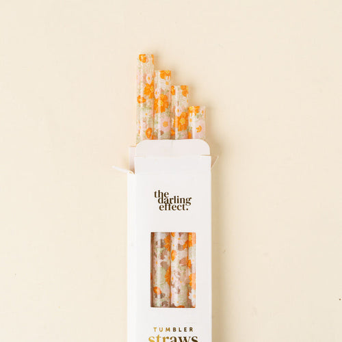 A white box labeled "the-darling-effect" holds five BPA-free Bouquet Beauty Sage 40 oz Tumbler Straws with orange and yellow floral patterns, shown on a light cream background.