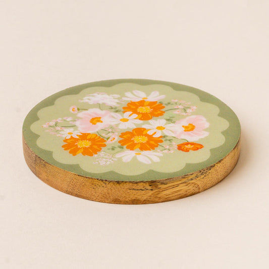 The-darling-effect's Bouquet Beauty Sage Wood Enamel Coaster features a green top with orange and white flower illustrations and green leaves, adding charm to any setting.