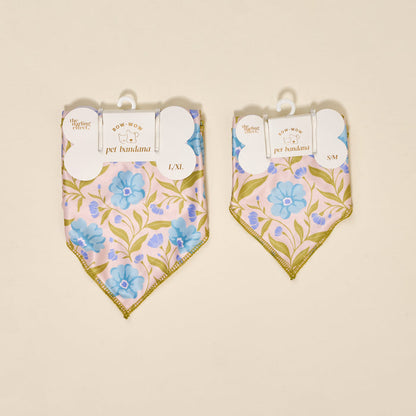 Two aqua floral cotton dog bandanas by The Darling Effect, labeled L/XL and S/M, hang side by side. Each displays “Bow-Wow Pet Bandana-Poppin' Petals Aqua” tags and the brand name.