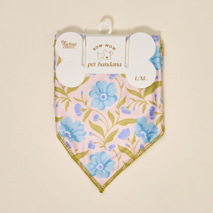 The Darling Effect’s Bow-Wow Pet Bandana-Poppin' Petals Aqua is a folded L/XL cotton bandana for pets, featuring blue floral and green leaf patterns on a light background, packaged as “Bow-Wow Pet Bandana.”.