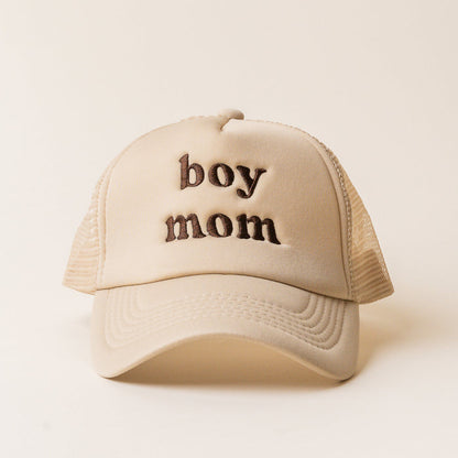 The Darling Effect Boy Mom Trucker Hat features a beige design with mesh sides and "boy mom" embroidered in brown on the front.