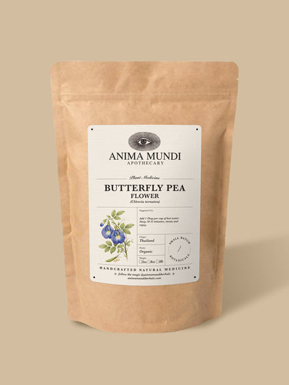 A kraft paper stand-up pouch of Anima Mundi Apothecary Butterfly Pea Flower herbal tea, set against a solid beige background.