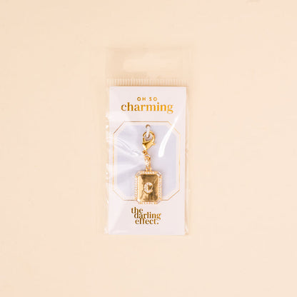 The C Jewelry Charm Initial Letter Gold by the-darling-effect is a gold-plated charm, perfect for personalized jewelry. It comes on an OH SO charming card, packaged in clear plastic with a light beige background.