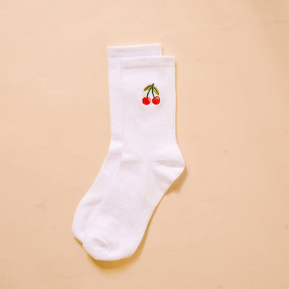 The Darling Effect’s Cherries Embroidered Crew Socks feature a white base with red cherry and green stem embroidery—colorful, playful socks for women.