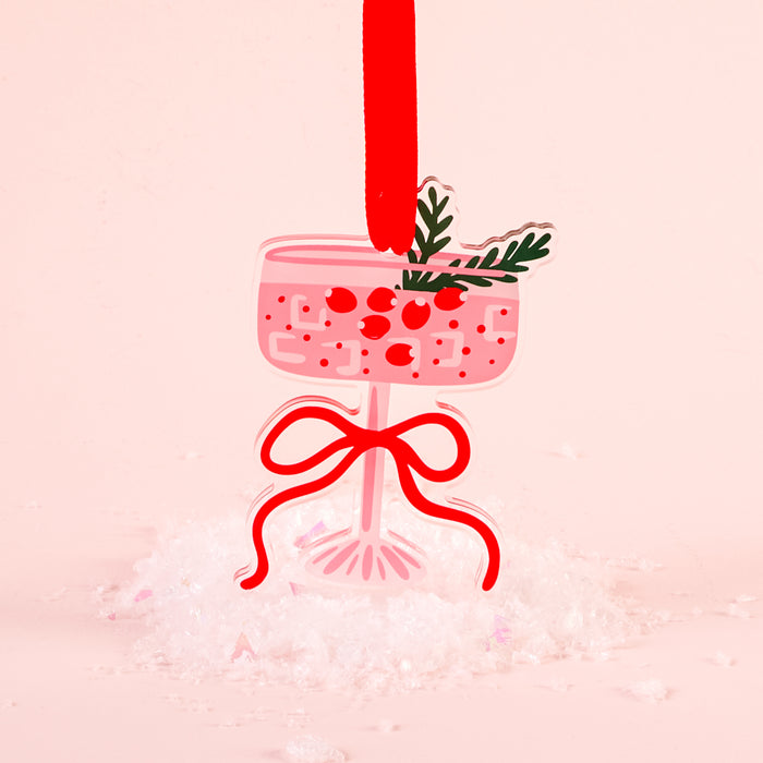 The Darling Effect's Cranberry Cosmo Holiday Tree Ornament features a pink cocktail glass shape with red berries, green leaves, and a red ribbon—an eye-catching festive decoration ideal for your holiday display.