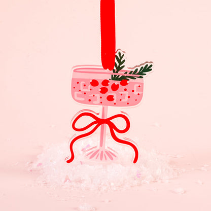 The Darling Effect's Cranberry Cosmo Holiday Tree Ornament features a pink cocktail glass shape with red berries, green leaves, and a red ribbon—an eye-catching festive decoration ideal for your holiday display.