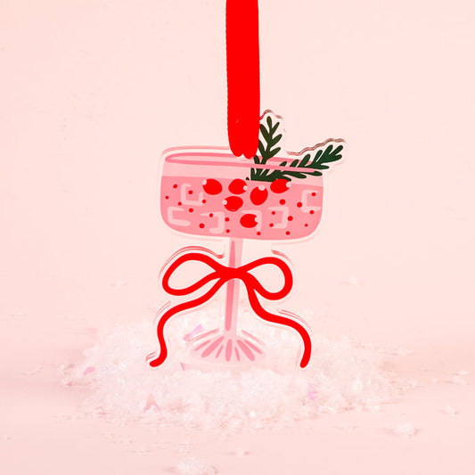The Darling Effect's Cranberry Cosmo Holiday Tree Ornament features a pink cocktail glass shape with red berries, green leaves, and a red ribbon—an eye-catching festive decoration ideal for your holiday display.