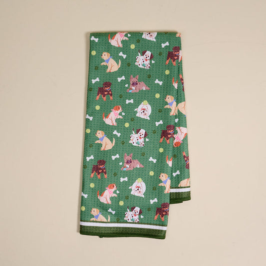 The Darling Effect's Dog Days Waffle Tea Towel features a green cartoon dog, white bone, and yellow dot pattern—absorbent and ideal for everyday kitchen use.