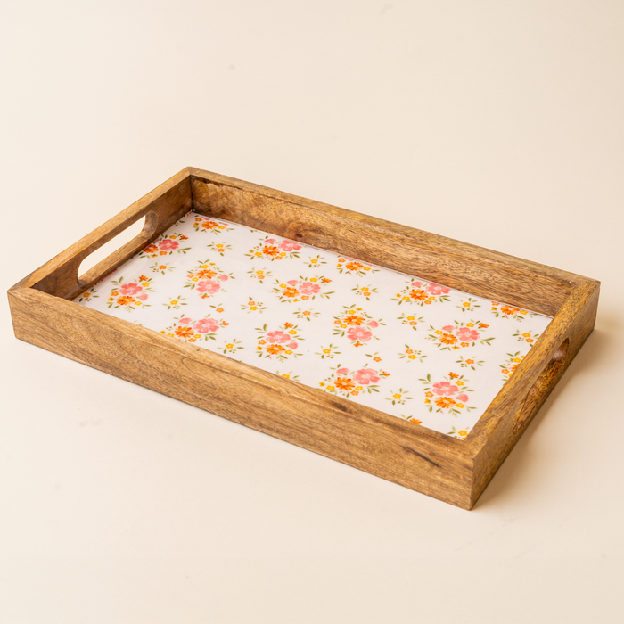 The-darling-effect Endless Daydream Cream Rectangle Wood Enamel Tray features short-side handles and a white base with pink-orange floral and green leaf patterns—ideal as a charming serving tray.