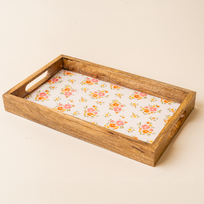 The-darling-effect Endless Daydream Cream Rectangle Wood Enamel Tray features short-side handles and a white base with pink-orange floral and green leaf patterns—ideal as a charming serving tray.