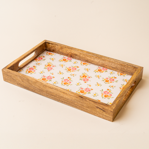 The-darling-effect Endless Daydream Cream Rectangle Wood Enamel Tray features short-side handles and a white base with pink-orange floral and green leaf patterns—ideal as a charming serving tray.