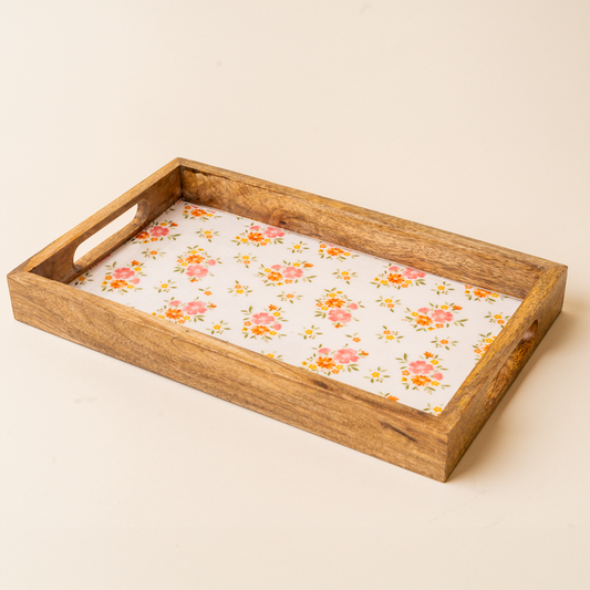 The-darling-effect Endless Daydream Cream Rectangle Wood Enamel Tray features short-side handles and a white base with pink-orange floral and green leaf patterns—ideal as a charming serving tray.