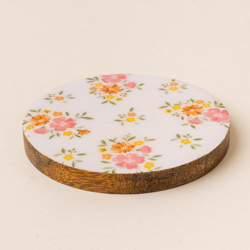 The Endless Daydream Cream Wood Enamel Coaster by the-darling-effect features pink and orange flowers with green leaves on a white surface, offering a decorative and durable touch, shown on a light beige background.