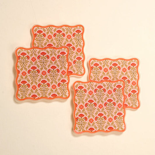 The Darling Effect’s Everbloom Dusty Rose Table Talk Acrylic Coaster Set features four scalloped coasters with a floral red and pink design—perfect for adding charm to your table decor.