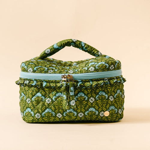 The Darling Effect’s Everbloom Forest Green Glam & Go Quilted Cosmetic Bag features a vintage floral pattern and blue ruffled zipper—perfect for stylish travel organization.