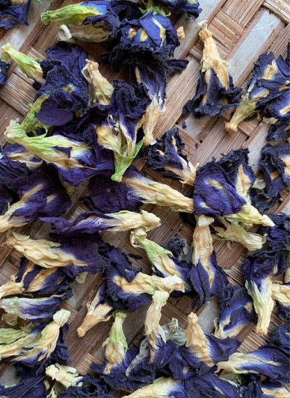 Dried butterfly pea flowers on a wooden surface