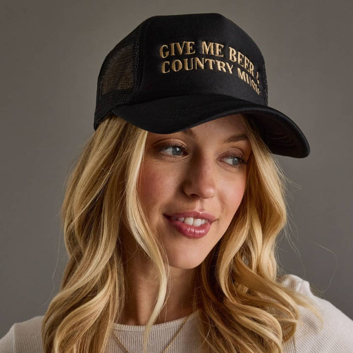 Woman wearing a black cap with text, against a neutral background