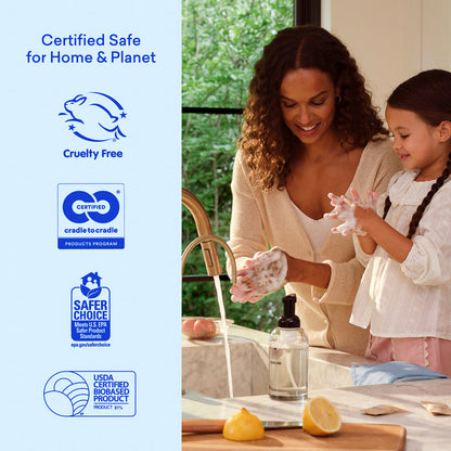 A smiling woman and young girl wash their hands at the kitchen sink with the Hand Soap Starter 2-Pack. Logos on the left show it's cruelty free, cradle to cradle certified, Safer Choice, and USDA certified biobased.