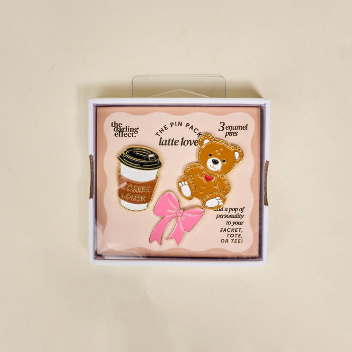 Latte Love The Pin Pack from The Darling Effect includes 3 enamel pins—a coffee cup, teddy bear, and pink bow—perfect collectible accessories for any pin lover.