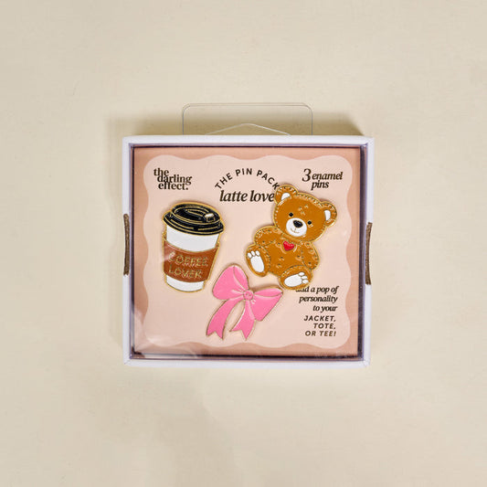 Latte Love The Pin Pack from The Darling Effect includes 3 enamel pins—a coffee cup, teddy bear, and pink bow—perfect collectible accessories for any pin lover.