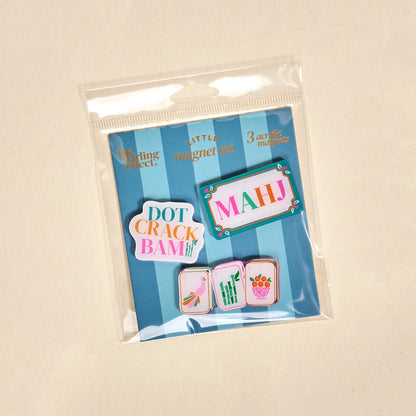 The Darling Effect's Let's Play Mahjong Little Magnet Set includes 3 acrylic magnets with Mahjong tiles and the words Dot, Crack, and Bam on a blue striped background—fun fridge decor!.