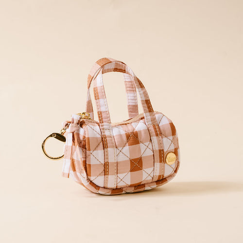 Mini gingham duffle bag charm with gold keyring and hardware, orange-and-white plaid