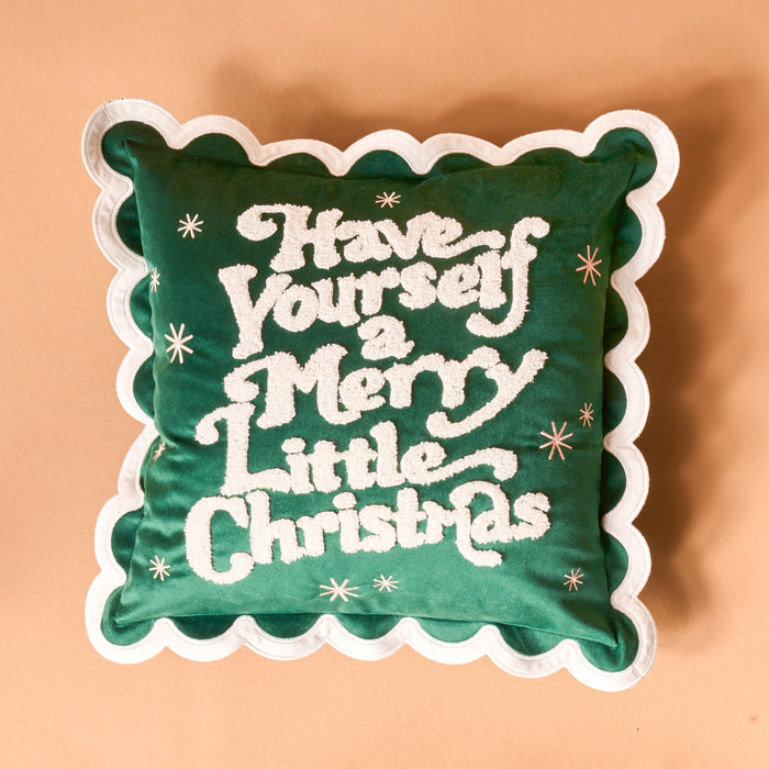 The Darling Effect's Merry Little Christmas Scalloped Square Throw Pillow features green fabric, white scalloped edges, embroidered festive text, and star accents—perfect for adding a cozy touch to your holiday decor.