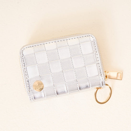 The Darling Effect Metallic Silver Zip Around Wallet features a gold zipper, card slots, and a convenient keychain.