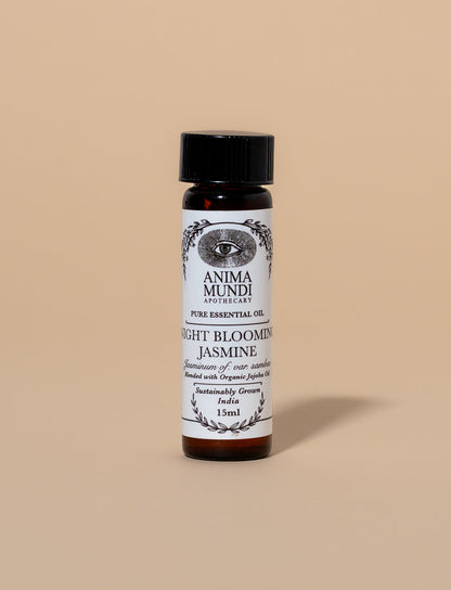 Bottle of Anima Mundi Night Blooming Jasmine essential oil on a beige background