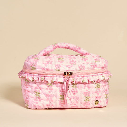 The Darling Effect's Oh So Fancy Pink Glam & Go Quilted Cosmetic Bag features a floral print, ruffles, and gold zipper with tassel—ideal for stylish travel makeup organization.
