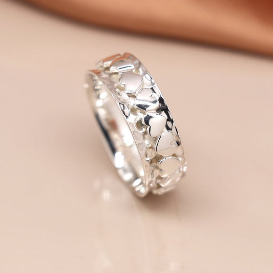 Pom Sterling Silver Hammered Spinning Ring With Band Of Hearts