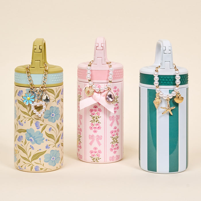 The Darling Effect’s Poppin' Petals Aqua 6 oz Lil' Bitty Bottles feature chic beaded charm necklaces with floral, bow, and striped pastel designs—perfect for stylish hydration on the go.