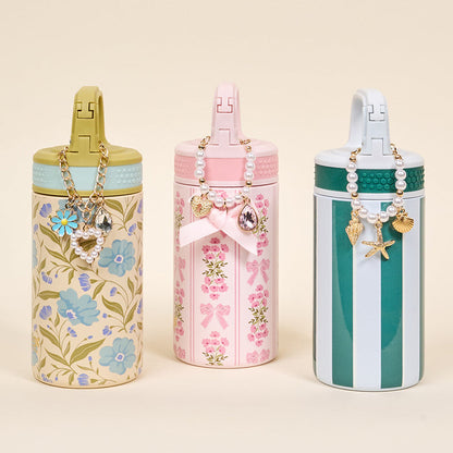 The Darling Effect’s Poppin' Petals Aqua 6 oz Lil' Bitty Bottles feature chic beaded charm necklaces with floral, bow, and striped pastel designs—perfect for stylish hydration on the go.