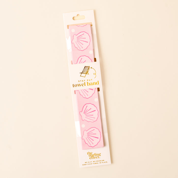 The-darling-effect's Put Towel Band-Seashells Pink Stay, featuring white polka dots and pink seashells with gold text, is shown against a light background—a stylish no-slip towel holder for your beach chair.