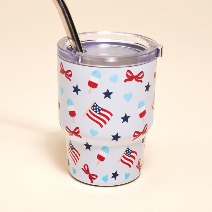 The Darling Effect's Red, White, & Bows 2 oz Tiny Tumbler features a metal straw and American flag, star, heart, bow, and popsicle designs—patriotic and fun!.