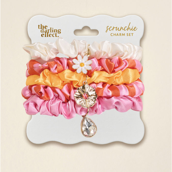 The Sicily Stripes Pink Scrunchie Charm Set by The Darling Effect features cream, pink, and orange stripes with a daisy charm and a teardrop gem for playful style.