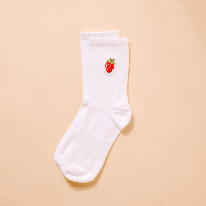 The Darling Effect’s Strawberry Embroidered Crew Socks are white, ribbed women’s socks with a small red strawberry and green leaves stitched near the top—ideal for fans of playful, embroidered socks.