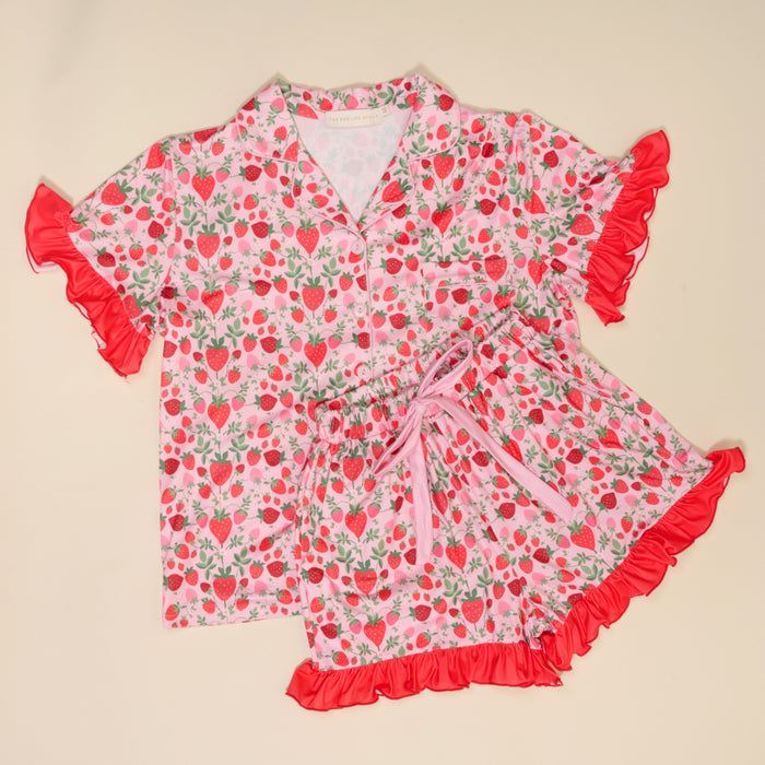 The Darling Effect’s Strawberry Fields Slumber Party Pajama Shorts Set features a scattered strawberry print and ruffle-trimmed sleeves and shorts, all in ultra-soft fabric for a comfy, relaxed fit you’ll love to lounge in.