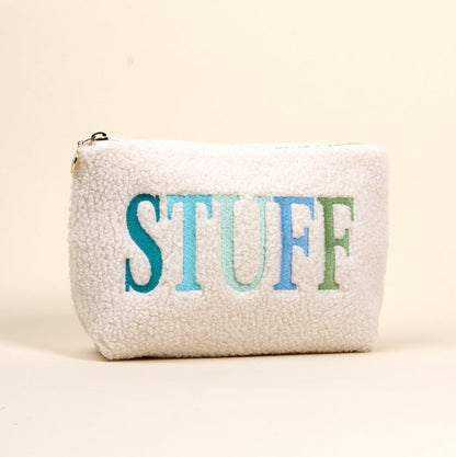 The Darling Effect Stuff Edit Teddy Pouch is a white, fuzzy zippered pouch with "STUFF" embroidered in large blue, teal, and green letters on the front against a light background.