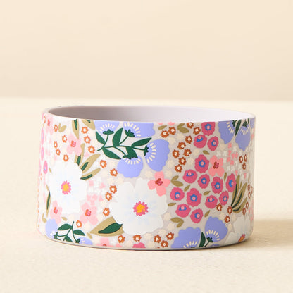 The Darling Effect Sweet Meadow Purple Tumbler Silicone Boot features a charming floral pattern with white, purple, and pink flowers plus green leaves—perfect to add flair as a No-Slip accessory for your tumbler.